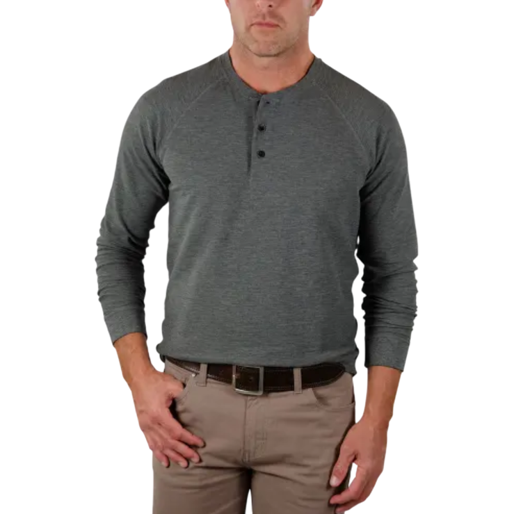 A male model is wearing a gray long-sleeve henley shirt with three buttons, paired with khaki pants and a dark brown belt.