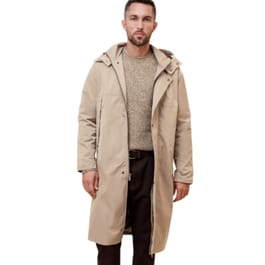 Beige long hooded anorak with a front zip closure and snap buttons, worn over a textured sweater and dark pants.