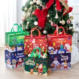 Festive gift bags with Christmas-themed designs, featuring Santa, reindeer, Christmas trees, and seasonal greetings, are arranged around a decorated Christmas tree.