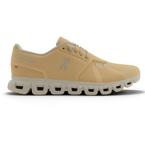 Beige athletic shoe with a unique sole design featuring hollow sections, showcasing a logo on the side and Swiss engineering text.