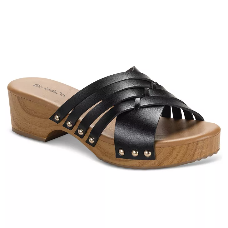 Style & Co. Darynn Clog Sandals feature black crisscross leather straps with stud accents on a wooden sole with a low heel, creating a stylish open-toe design.