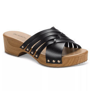 Style & Co. Darynn Clog Sandals feature black crisscross leather straps with stud accents on a wooden sole with a low heel, creating a stylish open-toe design.