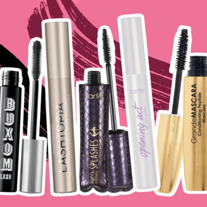 Various brands of mascara tubes with attached wands are displayed against a pink background.