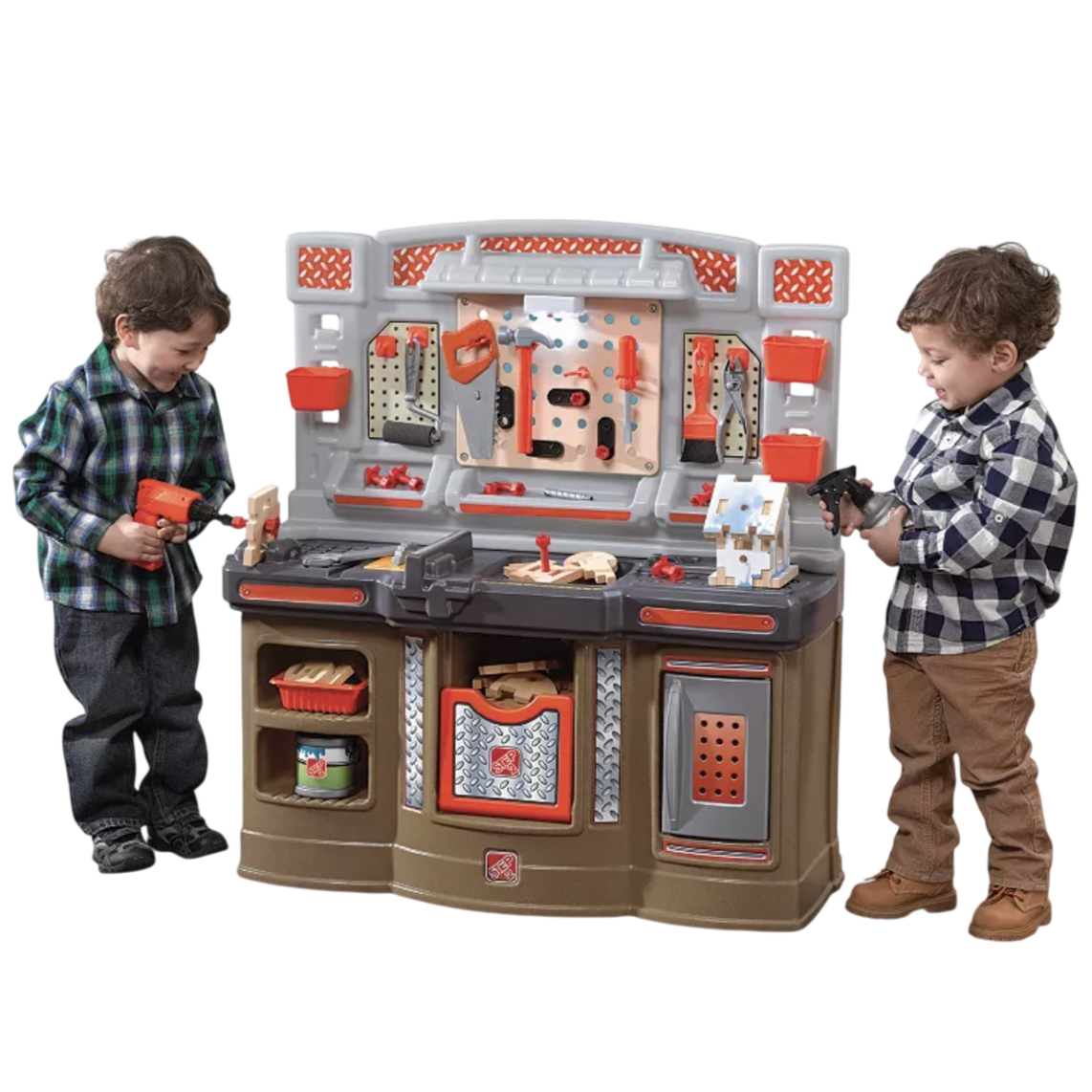 Children are playing with a toy workbench set featuring tools like a drill, saw, pliers, and a vise, along with a small wooden house project.
