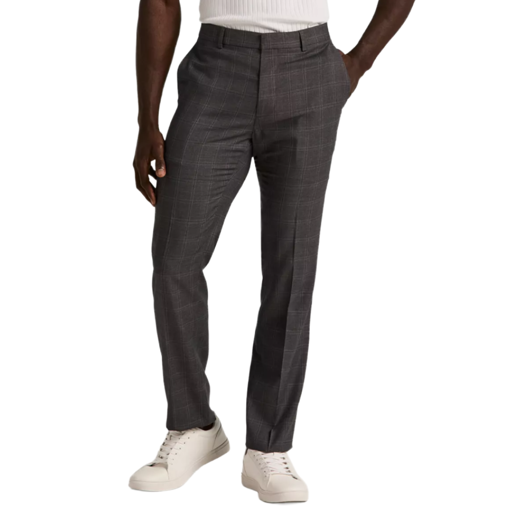 Gray plaid trousers paired with white sneakers, worn by a person in a white ribbed top.