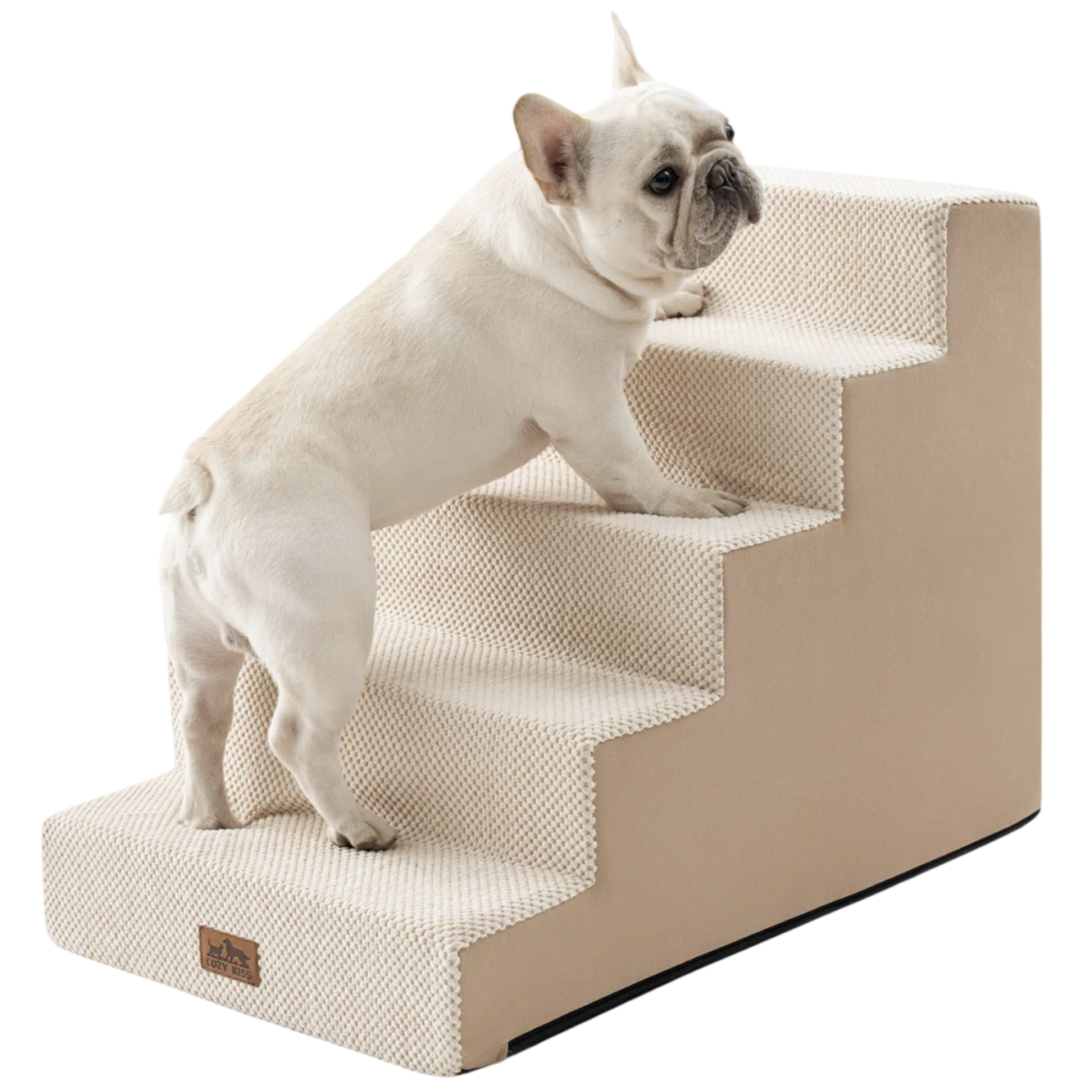 A small dog is using beige pet stairs designed for easy access to higher surfaces. The stairs have a textured surface for better grip.