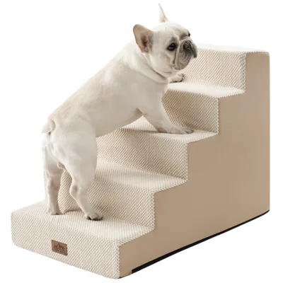 A small dog is using beige pet stairs designed for easy access to higher surfaces. The stairs have a textured surface for better grip.