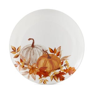 A set of four round dining plates featuring a painted autumnal design with pumpkins and leaves in warm shades of orange and brown.