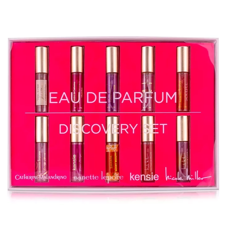 A set of six small cylindrical Eau de Parfum bottles by various designers displayed in pink packaging.