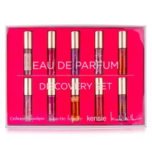 A set of six small cylindrical Eau de Parfum bottles by various designers displayed in pink packaging.