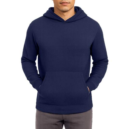A man is wearing a navy blue, ribbed hooded sweatshirt with a front pouch pocket, paired with gray pants.