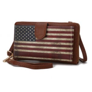 The MKF crossbody bag features a vintage-style American flag design on the front, with brown leather trim and a strap. It's compact and has a secure zipper closure, ideal for carrying essentials.
