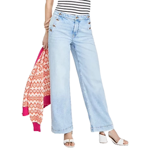 Light blue wide-leg jeans with button details on the front, paired with a striped top, pink and orange patterned sweater, and white heeled sandals.