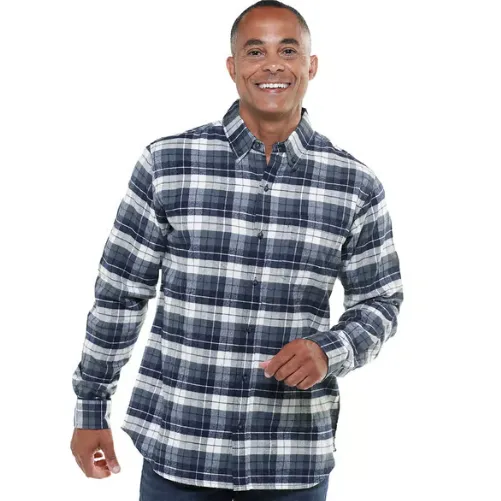 A man wears a blue and white plaid flannel shirt, featuring long sleeves and a button-up front.