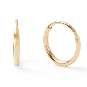 A pair of simple, gold hoop earrings with a sleek, minimalist design.