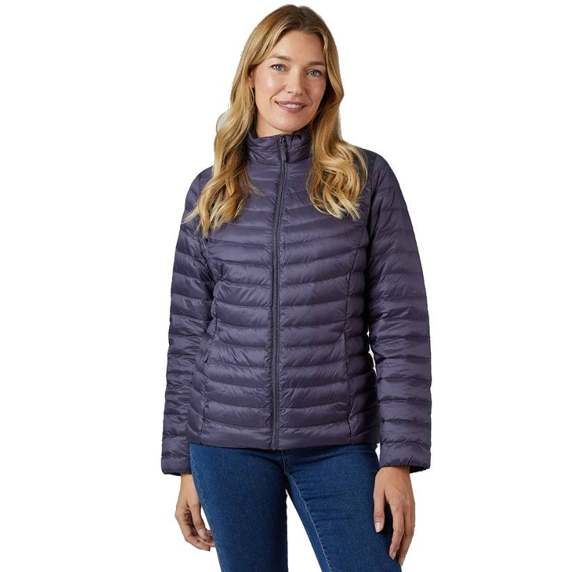 A woman is wearing a purple, quilted, zip-up puffer jacket paired with blue jeans.