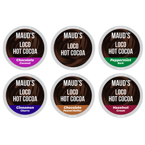 A 48-count assortment of Maud's Loco Hot Cocoa pods featuring six flavors: Chocolate Coconut, Peppermint Bark, Cinnamon Churro, Chocolate Peanut Butter, and Hazelnut Cream. Each flavor is labeled dairy-free.