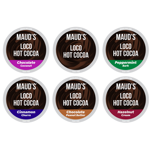 A 48-count assortment of Maud's Loco Hot Cocoa pods featuring six flavors: Chocolate Coconut, Peppermint Bark, Cinnamon Churro, Chocolate Peanut Butter, and Hazelnut Cream. Each flavor is labeled dairy-free.