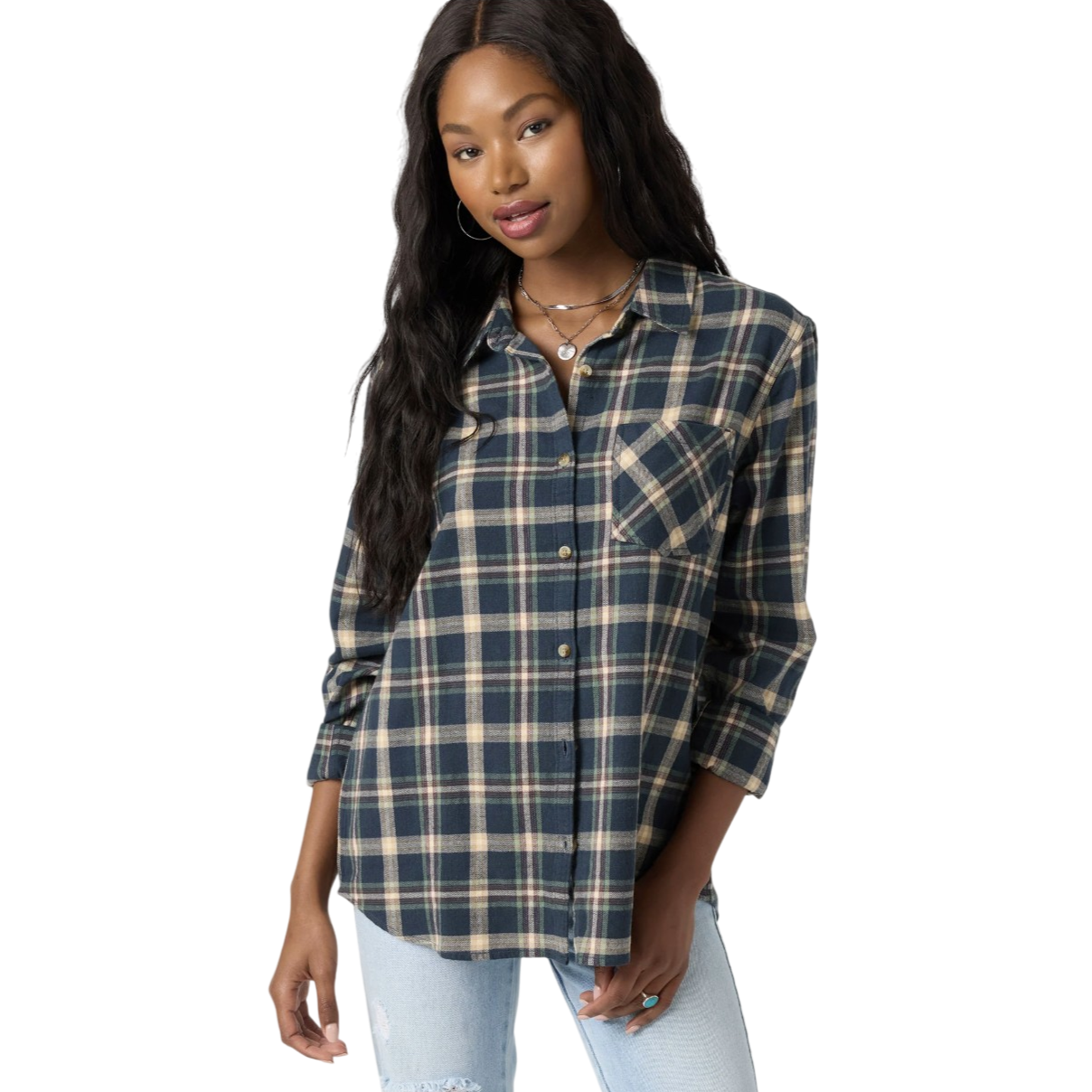 A woman is wearing a blue and beige plaid button-up shirt with long sleeves, paired with light-wash, ripped jeans. She accessorizes with hoop earrings and layered necklaces.