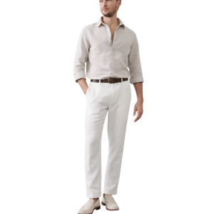 A man wears a light beige button-up shirt, white pinstripe trousers, a brown belt, and light beige loafers, standing against a plain white background.