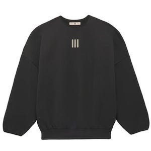 A black Fear of God crewneck sweatshirt features a minimalist design with three vertical stripes on the chest and a loose fit with ribbed cuffs and hem.