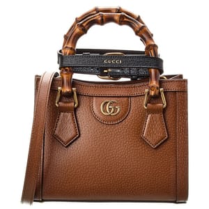 Brown Gucci leather handbag with bamboo handles and gold-tone logo.