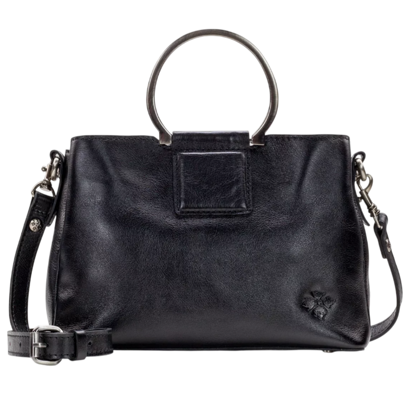 A black leather handbag with circular metal handles and a detachable shoulder strap, featuring a small embossed floral detail.