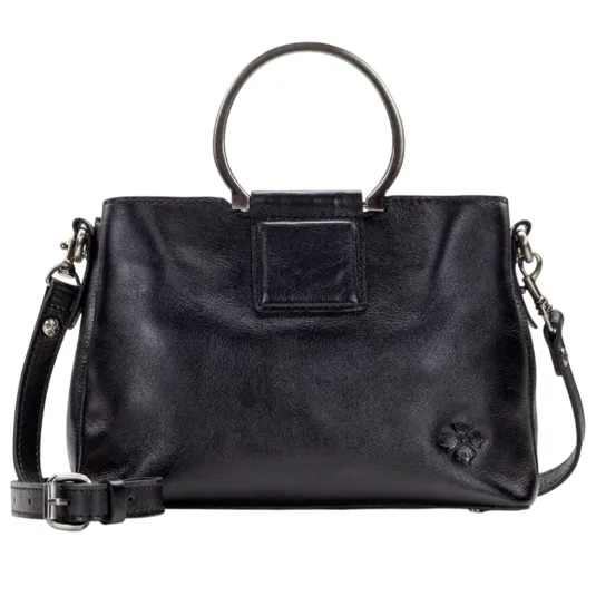 A black leather handbag with circular metal handles and a detachable shoulder strap, featuring a small embossed floral detail.