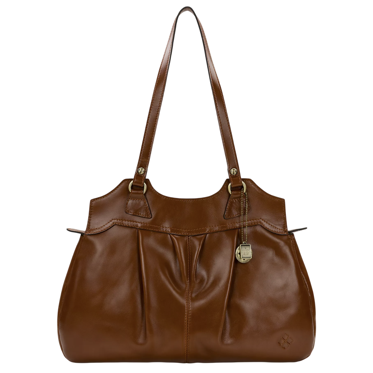 A brown leather handbag with double handles and a decorative metal charm. The design features pleats on the front and a small embossed logo in the corner.