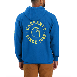Blue Carhartt hoodie featuring the logo and text \“Carhartt Since 1889\“ in yellow on the back. The person is also wearing brown pants.