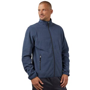 A man is wearing a blue fleece jacket with a high collar, full-zip front, and a zippered pocket on the chest.