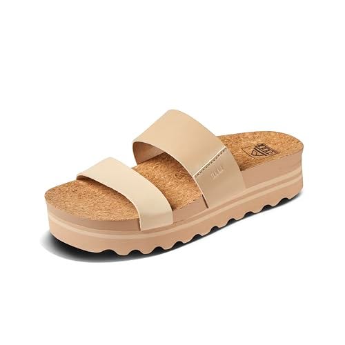 Beige Reef Cushion Vista Hi sandals with two wide straps, a cork footbed, and a wavy-edged platform sole.