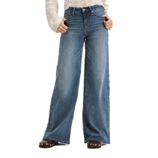 Wide-leg blue jeans paired with a lace long-sleeve top and brown shoes with metal studs.