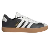 Black and white Adidas sneaker with three white stripes, a brown gum sole, and a gold Adidas logo on the side.