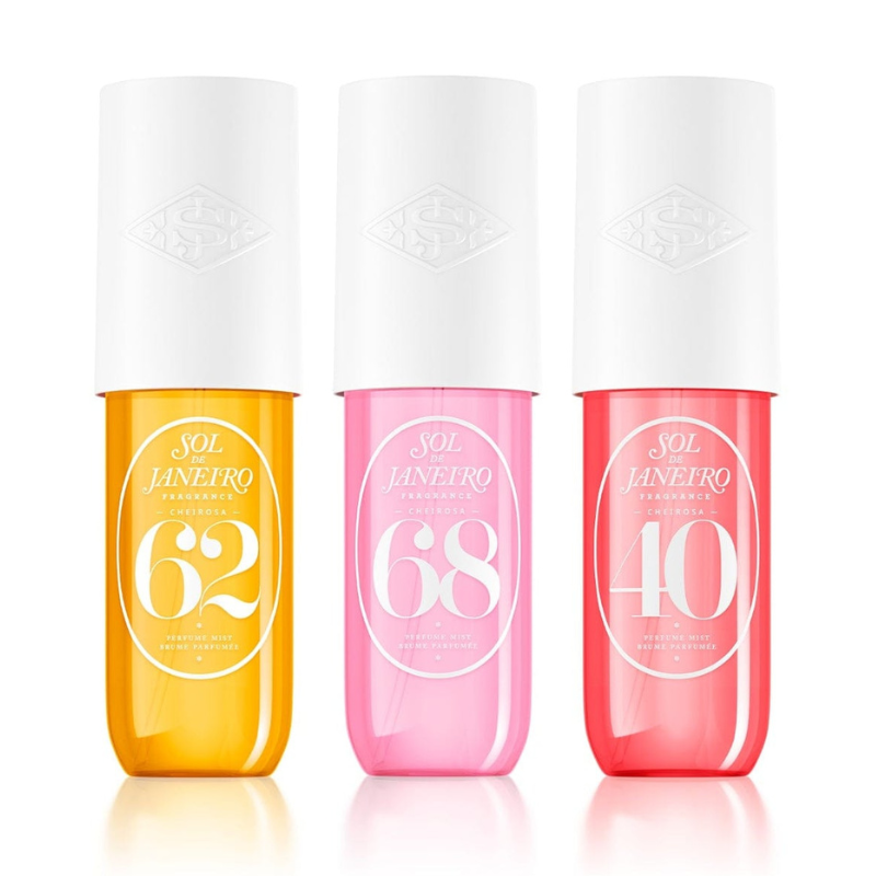 Three Sol de Janeiro Cheirosa fragrance mists in 62 (yellow), 68 (pink), and 40 (red) come with white caps, each offering unique scents in colorful, sleek bottles.