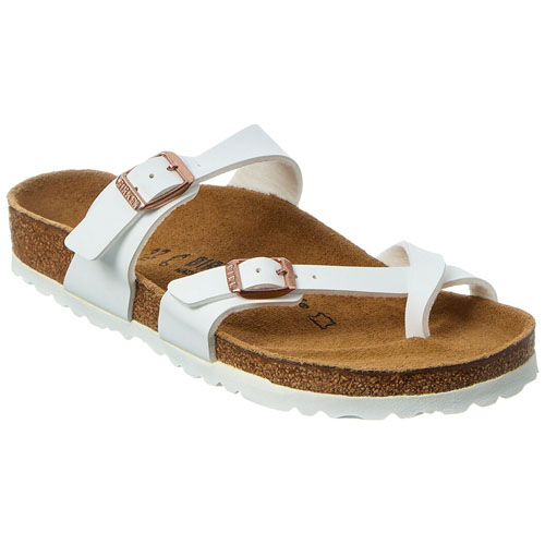 White sandal with a cork footbed, white straps, and adjustable metal buckles.