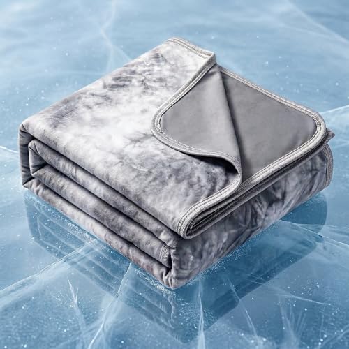 A folded gray and white blanket with a soft, velvety texture is placed on an ice-like surface.