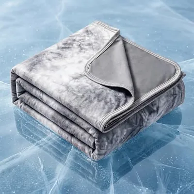 A folded gray and white blanket with a soft, velvety texture is placed on an ice-like surface.