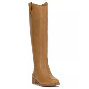 A tan knee-high boot with a low block heel and side pull tab, featuring smooth leather and decorative stitching.