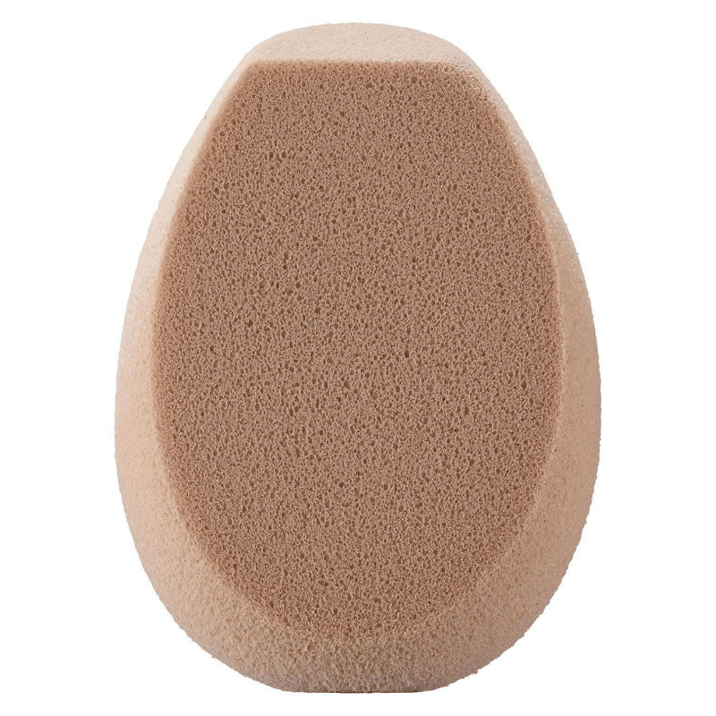 A beige, oval-shaped makeup sponge with a flat edge, used for blending foundation and other cosmetics for a smooth application.