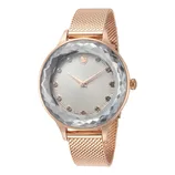 A rose gold watch with a mesh band features a faceted crystal bezel, sunburst dial, and crystal hour markers.