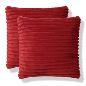 Two red square throw pillows with a ribbed texture.