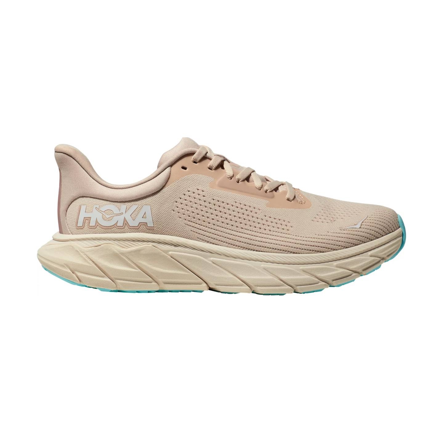 Tan Hoka running shoe with cushioned sole and aqua-colored outsole accents.