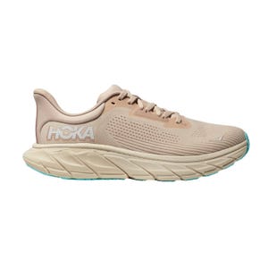 Tan Hoka running shoe with cushioned sole and aqua-colored outsole accents.