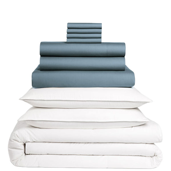 A stacked set of bedding items, including dark-colored sheets, pillowcases, and white pillows with a comforter.