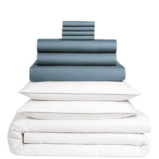 A stacked set of bedding items, including dark-colored sheets, pillowcases, and white pillows with a comforter.