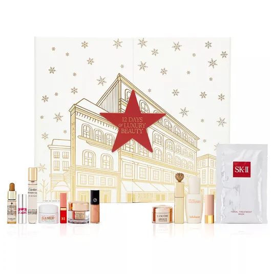 12 Days of Luxury Beauty set featuring skincare and cosmetic items from brands like La Mer, Lancôme, SK-II, and more, including creams, serums, masks, lip products, and fragrances, presented in a festive box with a gold and red design.