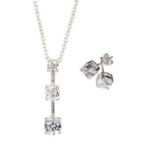 A silver-tone necklace with a vertical pendant featuring three round cubic zirconia stones, paired with matching round cubic zirconia stud earrings.