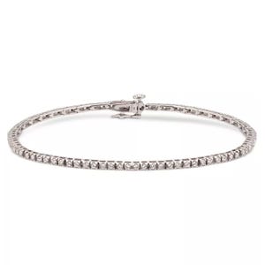Sterling silver tennis bracelet set with 1.5 carats total weight of round-cut diamonds, featuring a sleek design and a secure clasp.