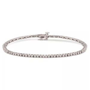 Sterling silver tennis bracelet set with 1.5 carats total weight of round-cut diamonds, featuring a sleek design and a secure clasp.
